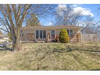 Well-maintained one-story home with a stone facade and established landscaping in the front yard at 21 E Tilden Dr, Brownsburg, IN 46112