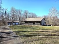 Ranch-style home with a covered front porch and detached two-car garage set on a generous lot at 2389 Bill Smith Rd, Martinsville, IN 46151