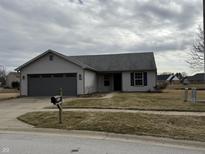 Charming single-story home with a gray exterior and attached garage at 2418 Shorewood Dr, Lebanon, IN 46052
