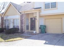 Two-story home featuring an attached garage, tidy lawn, and welcoming covered front entryway at 2449 Chaseway Ne Ct # Blk B, Indianapolis, IN 46268