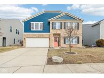 Inviting two-story home featuring brick and blue siding, a two-car garage, and a neatly landscaped front yard at 3132 W Meadowbend Dr, Monrovia, IN 46157
