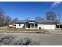 Charming single-story home featuring new metal roof and attached garage in a quiet neighborhood at 504 Iroquois Dr, Anderson, IN 46012