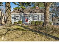 Charming single-story home with a well-maintained lawn and mature trees, creating a welcoming curb appeal at 5935 Compton St, Indianapolis, IN 46220