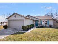 Charming single-story home features a well-maintained lawn, attached garage, and inviting curb appeal at 7711 Winterberry Ct, Noblesville, IN 46062