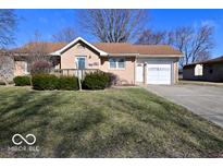 Charming single-story home features a cozy front porch and well-maintained lawn at 1040 E Buchanan St, Plainfield, IN 46168