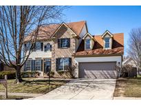 Charming two-story home featuring a brick and siding facade, attached two-car garage, and well-maintained landscaping at 10628 Blackthorn Ct, Fishers, IN 46038