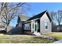 Charming gray home featuring a gabled roof, well-maintained lawn, and welcoming front entrance with a fenced-in yard at 1152 Christian Ave, Noblesville, IN 46060