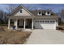 Charming single-story home with inviting front porch, attached garage, and a well-lit driveway at 14383 Coyote Ridge Dr, Noblesville, IN 46060