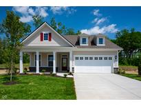 Charming single-Gathering home with a manicured lawn, two car garage, and inviting front porch at 14383 Coyote Ridge Dr, Noblesville, IN 46060