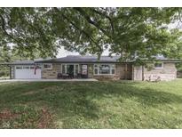 Charming stone ranch home with a well-maintained front yard and an attached two-car garage at 1459 S Josephine St, Martinsville, IN 46151
