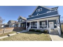 Charming two-story home featuring a welcoming front porch and well-maintained lawn at 1505 S Alabama St, Indianapolis, IN 46225