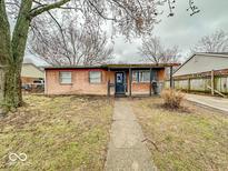Charming single-story brick home with a cozy covered front porch and walkway at 3423 N Sadlier Dr, Indianapolis, IN 46226