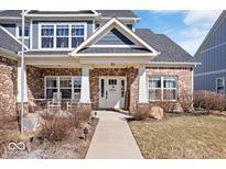 Charming brick home featuring a covered front porch and landscaped yard at 4544 W Rising Sun Dr, New Palestine, IN 46163