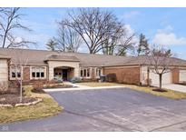 Charming brick home with an attached two-car garage and a paved driveway at 504 Bent Tree Ln, Indianapolis, IN 46260