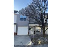 Charming townhome featuring a one-car garage, covered porch, and well-manicured landscaping at 504 Elkhart Dr, Westfield, IN 46074