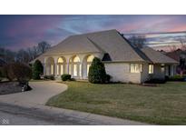 Attractive single story home features a large front yard, beautiful windows, and lovely landscaping at 6520 Forrest Commons Blvd, Indianapolis, IN 46227