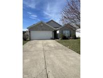Charming single-story home featuring a two-car garage, brick facade, and well-maintained lawn at 6886 W Raleigh Dr, McCordsville, IN 46055