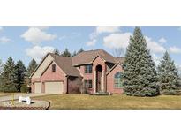 Stunning red brick two-story home featuring manicured landscaping and a two car attached garage at 7619 Bluebird Ct, Brownsburg, IN 46112