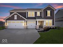 Beautiful two-story home featuring a three-car garage, landscaped yard, and welcoming front porch at 8861 Linton Ln, Brownsburg, IN 46112