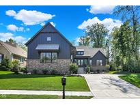 Charming home boasts professional landscaping, a brick facade, and a driveway leading to an attached garage at 907 Oak Terrace Rd, Westfield, IN 46074