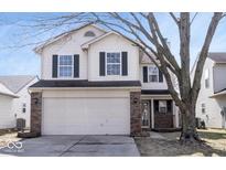 Charming two-story home featuring a two-car garage, brick accents, and classic black shutters at 10353 Liverpool Way, Indianapolis, IN 46236