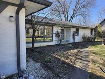 Charming single-story home featuring painted brick, mature trees, and a well-maintained front yard at 10821 E County Road 750 N, Brownsburg, IN 46112