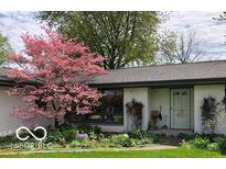 Charming single story home with beautiful landscaping and a lovely pink dogwood tree in the front yard at 10821 E County Road 750 N, Brownsburg, IN 46112