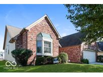 Charming red brick home with a bay window and well-maintained landscaping at 10891 Santa Anita Ct, Carmel, IN 46280