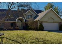 Charming single-Gathering home boasting a well-maintained lawn and an attached two-car garage at 1110 Butternut Dr, Columbus, IN 47201