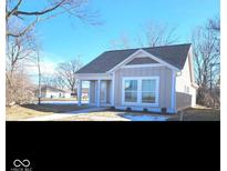 Charming single-story home with gray siding, white trim, and a well-manicured front yard at 1974 Ralston Ave, Indianapolis, IN 46218