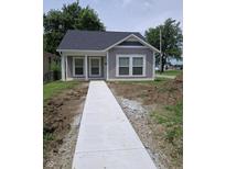 Charming home with a new concrete walkway and freshly landscaped front yard at 1974 Ralston Ave, Indianapolis, IN 46218