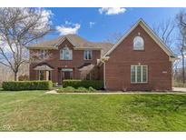 Charming brick two-story home with a manicured lawn and mature landscaping at 2163 Laurel Leaf Ln, Avon, IN 46123