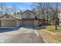 Inviting home exterior showcasing a two-car garage and well-maintained landscaping at 2215 Van Ness Pl, Indianapolis, IN 46240