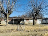A single-story brick home with a covered front porch and mature trees at 260 W 33Rd St, Indianapolis, IN 46208