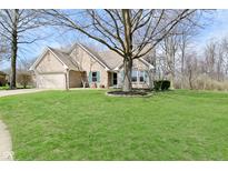 Charming single-story brick home with a well-manicured lawn and mature trees at 2668 Cressmoor Cir, Indianapolis, IN 46234