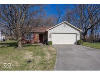 Charming single-Gathering home with a two-car garage, set amidst mature trees and a well-maintained lawn at 4238 Vestry Ct, Indianapolis, IN 46237