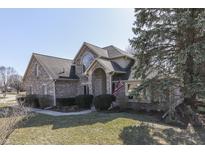 Charming brick two-story home with manicured lawn and inviting entryway at 4927 Auburn Ford, Greenwood, IN 46142