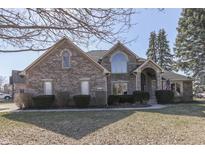 Charming brick two-story home with manicured lawn and inviting entryway at 4927 Auburn Ford, Greenwood, IN 46142