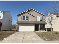 Charming two-story home with neutral siding, attached two car garage, and well-manicured front lawn at 5672 High Timber Ln, Indianapolis, IN 46235