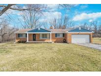 Charming brick ranch-style home with attached garage and well-manicured lawn at 5683 Boy Scout Rd, Lawrence, IN 46226
