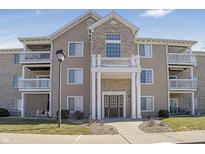 Attractive condo building showcasing a brick and siding facade, balconies, and manicured landscaping at 6525 Emerald Hill Ct # 207, Indianapolis, IN 46237