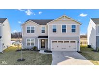 Charming two-story home featuring a well-kept lawn, and an attached two-car garage at 8523 Hulton Rd, Pendleton, IN 46064