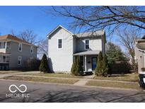 Charming two-story home with blue door and tidy landscaping features a well-maintained front yard and classic architectural details at 1334 Hannibal St, Noblesville, IN 46060