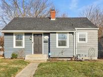 Charming single-story home with gray siding, brick chimney, and well-maintained front yard, creating a welcoming curb appeal at 1953 N Linwood Ave, Indianapolis, IN 46218