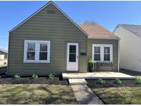 Charming home features meticulous landscaping, covered porch, and a well-maintained exterior at 2341 California St, Columbus, IN 47201