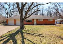 Charming brick ranch-style home with attached two-car garage and mature trees at 2371 E 98Th St, Indianapolis, IN 46280