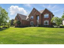 Beautiful brick home with a well-manicured lawn and lush landscaping at 2750 Joshua Dr, Carmel, IN 46033