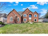 Elegant red brick two-story home with manicured lawn and beautiful landscaping at 2750 Joshua Dr, Carmel, IN 46033