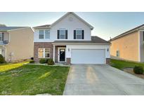 Two-story home featuring a brick and vinyl facade, attached two-car garage, and well-manicured lawn at 3153 Underwood Dr, Whiteland, IN 46184