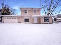 Two-story home featuring an attached garage, and snow-covered front yard at 3743 Celtic Dr, Indianapolis, IN 46235